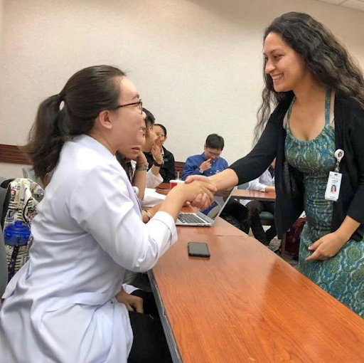 Medical student Le Nhan Tam (Class of 2014-2020) practicing patient communication during a clinical session with a physician at the hospital.